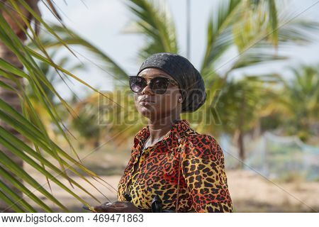 Woman With Black Headdress And Sunglasses Protecting From The Sun On A Beach In Keta Ghana West Afri