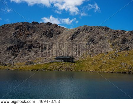 Scenic Mountain Panorama Of Idyllic Alpine Angelus Hut On Lake Shore In Nelson Lakes National Park T