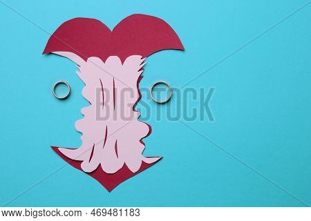 Divorce Concept. Paper Cutout Of Apple Core And Rings On Light Blue Background, Flat Lay With Space 