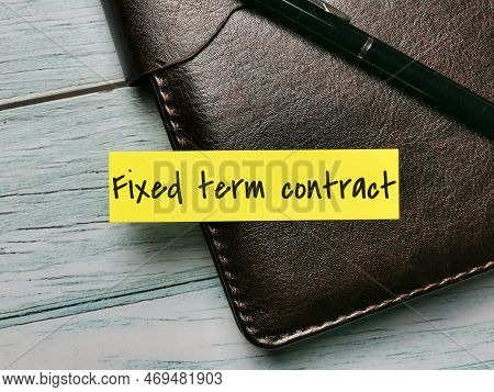 Word Fixed Term Contract Written On Sticky Note With A Pen.