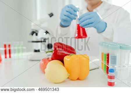 Scientist Check Chemical Food Residues In Laboratory. Control Experts Inspect Quality Of Fruits, Veg