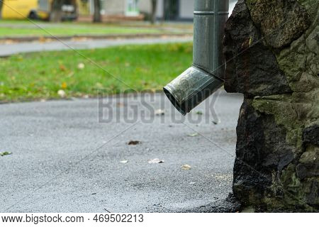 Downspout Of Rain Gutter Near The Side Of A House, Side View. Bottom Of Downspout.