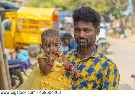 Puttaparthi, Andra Pradesh - India - January 21.2023: Portrait Of A Indian Man With His Small Daught