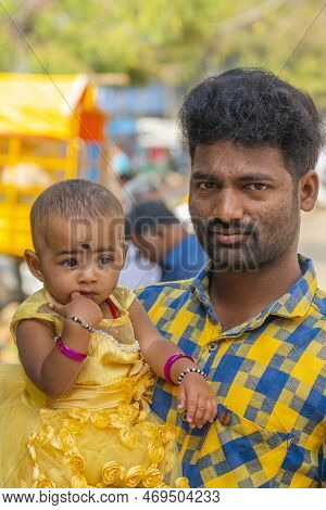Puttaparthi, Andra Pradesh - India - January 21.2023: Portrait Of A Indian Man With His Small Daught