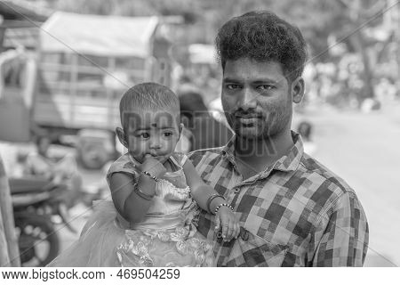 Puttaparthi, Andra Pradesh - India - January 21.2023: Portrait Of A Indian Man With His Small Daught