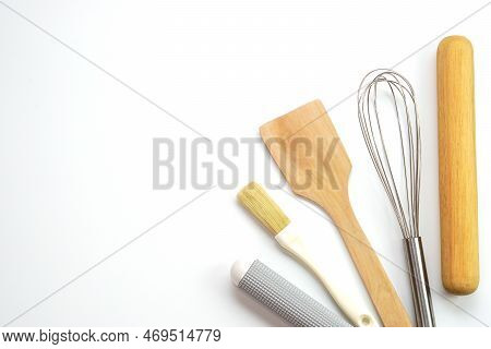 Top View Kitchenware Wooden Rolling Pin, Wooden Spatula And Egg Beater On White Background. Material
