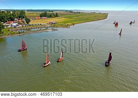 Aerial From Traditional Dutch Wooden Boats At The Ijsselmeer Near The Harbor From Laaxum In Frieslan