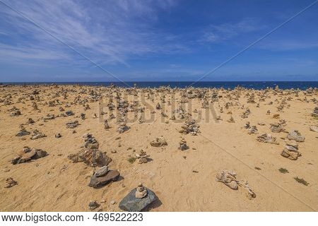 Beautiful View Of Coast Of Atlantic Ocean Of Island Of Aruba With Small Cairns Lined.