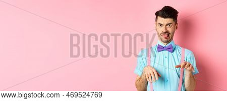 Funny Guy Looking At Something Disgusting With Aversion And Cringe, Show Tongue And Shaking Hands In