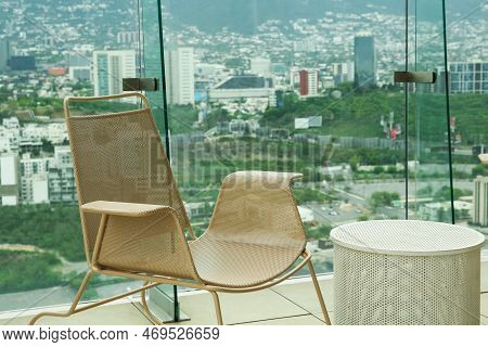 Coffee Table And Chair Against Picturesque Landscape Of City In Cafe