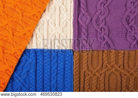 Knitted Blue, Lilac, Brown, Orange And Beige Background. Large Knitted Fabric With A Pattern. Close-
