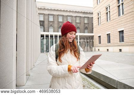 Stylish Ginger Girl, Tourist Walks With Digital Tablet Around City, Woman Connects To Iternet On Her