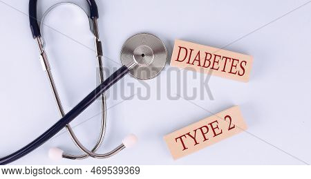 On A Blue Background, A Stethoscope And Wooden Block With The Word Diabetes Type2 .medical
