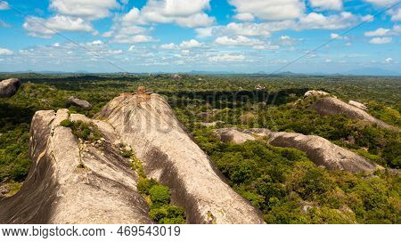 Aerial View Of Rocks Among The Rainforest And Jungle Against The Blue Sky And Clouds. Sri Lanka, Oka