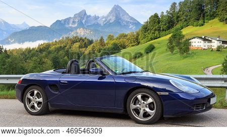 Berchtesgaden, Germany - July 25, 2021: Blue Roadster Porsche Boxster 986 With Mountain Watzmann And