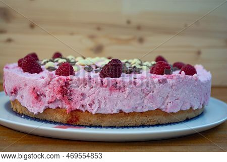 Rasperry Cake With Cream And White Chocolate On Wooden Board