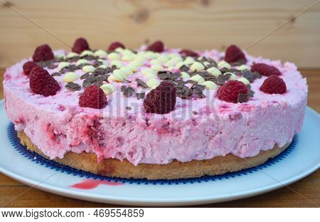 Rasperry Cake With Cream And White Chocolate On Wooden Board