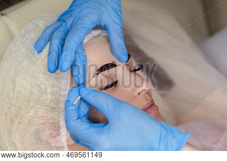 Microblading, Micropigmentation Eyebrows Work Flow In A Beauty Salon. Woman Having Her Eye Brows Dra