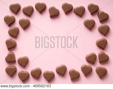 Chocolate Hearts Confections Frame On Pink, Copy Space