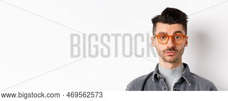 Attractive Brunette Man With Moustache, Wearing Stylish Glasses And Look Serious At Camera, No Emoti