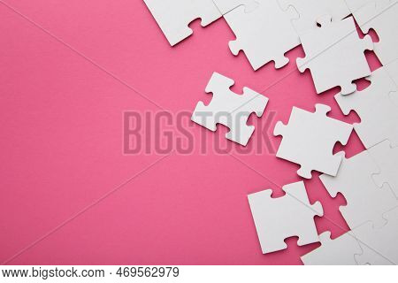 Close-up Of A Pile Of Uncompleted Elements Of A White Puzzle. A Huge Number Of Rectangular Pieces Fr