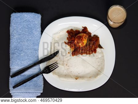 Kerala Tasty Special Breakfast Appam And Egg Roast With Tea In Dark Background