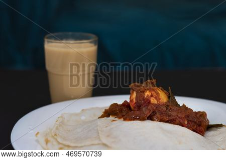 Kerala Tasty Special Breakfast Appam And Egg Roast With Tea In Dark Background