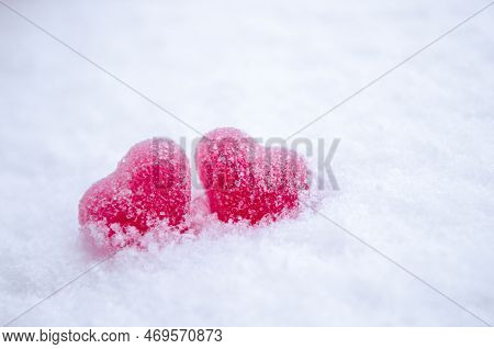 Two Red Sugar Marmalade Candies In Shape Of A Heart On White Snow