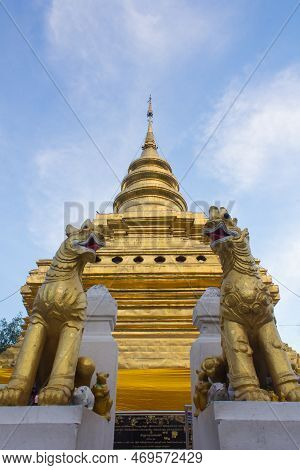 Singha Statue With Pagoda Wat Pra That Sri Chomthong Vora Vihan, Chiangmai Thailand