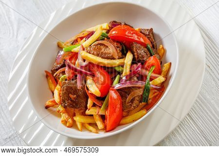 Lomo Saltado, Peruvian Dish Of Stir-fried Slices Of Beef Sirloin, Onions, Yellow Peruvian Chilis, An