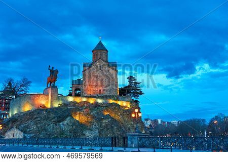 Evening Scenery Of The Metehi Assumption Church In Tbilisi With The Building's Lights On. Tbilisi, G