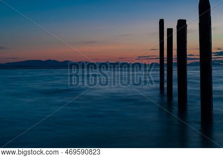 Night Picture Of Point Roberts Pilings And Silky Water At Twilight, Washington State, Usa