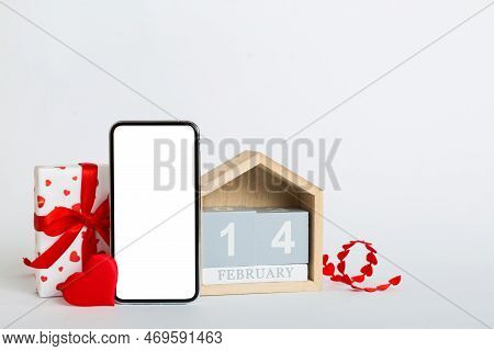 Mobile Phone With Blank Screen On Colored Background With Hearts, Calendar And Gift Box, Valentine D