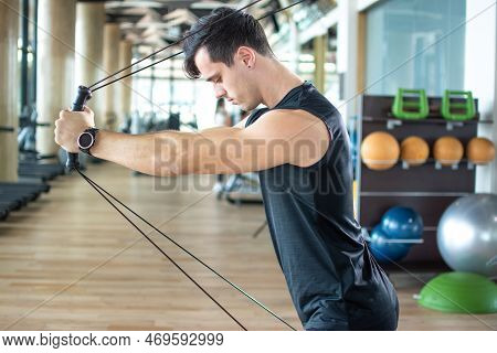 Man Pulling Cables. Handsome Athlete Male Lifting Up And Push Up On Sling To Maintain Muscle, Build 