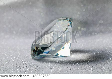Beautiful Dazzling Diamond On Shiny Glitter Background, Closeup. Precious Gemstone