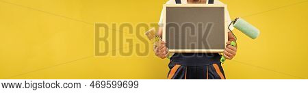 Cropped Man Housepainter In Work Clothes Hold Paint Roller Brush And Blackboard With Copy Space