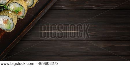 Sushi Roll Banzai On A Wooden Board, On A Wooden Background. Banner