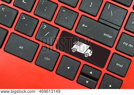 Laptop Keyboard With Delivery Truck Symbol. Transportation And Courier Logistics Shipping Service