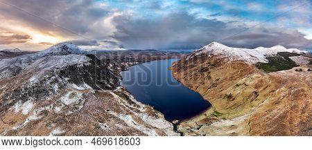Aerial View Of Altan Lough Next To The The Snow Covered Mount Errigal, The Highest Mountain In Doneg
