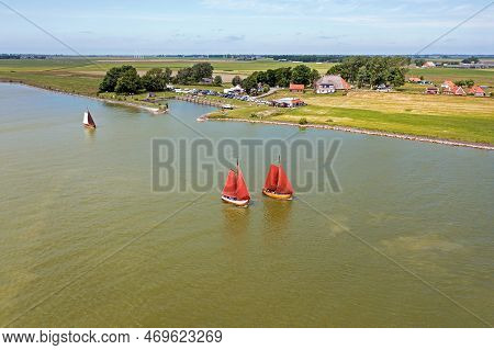 Aerial From Traditional Dutch Wooden Boats At The Ijsselmeer Near The Harbor From Laaxum In Frieslan
