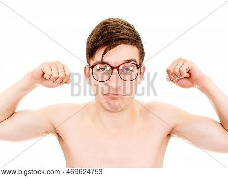 Skinny And Funny Young Man In Glasses Muscle Flexing On The White Background