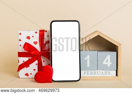 Mobile Phone With Blank Screen On Colored Background With Hearts, Calendar And Gift Box, Valentine D