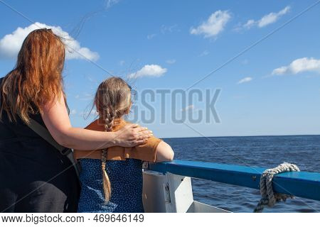 Mother And Gaughter On Ship On Blue Sea