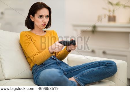 Hot-tempered Young Lady Playing Video Games At Home