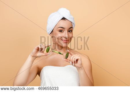 Beautiful Young Indian Woman Holding Greenstone Jade Facial Roller For Skin Care