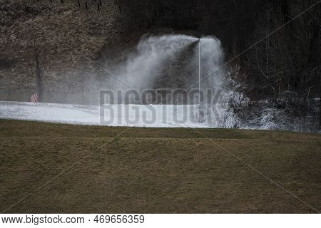 Snow Lance Cannon Producing Artificial Snow On Slopes And In Ski Resorts With Green Brownish Grass I