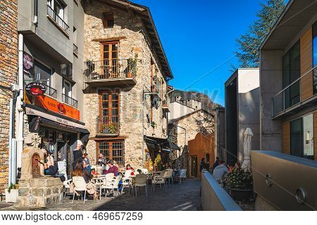 Andorra La Vella, Jan 2020 Old, Narrow Moody Paved Street With Stone Buildings. People In Local Pubs