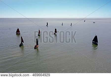 Aerial From Traditional Dutch Wooden Boats At The Ijsselmeer Near The Harbor From Laaxum In Frieslan