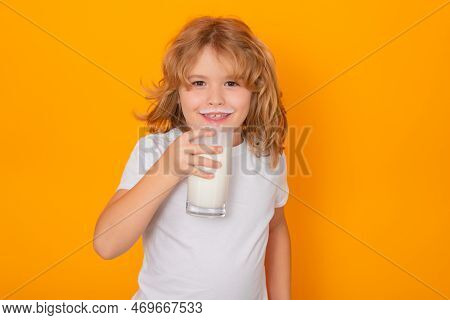 Kid Drink Milk With Funny Emotions On Yellow Background. Child Drinking Milk, Studio Portrait. Cute 