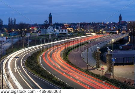 Long Exposure Of Evening Traffic On A Motorway Seen From Train Station Halfweg Zwanenburg In The Net